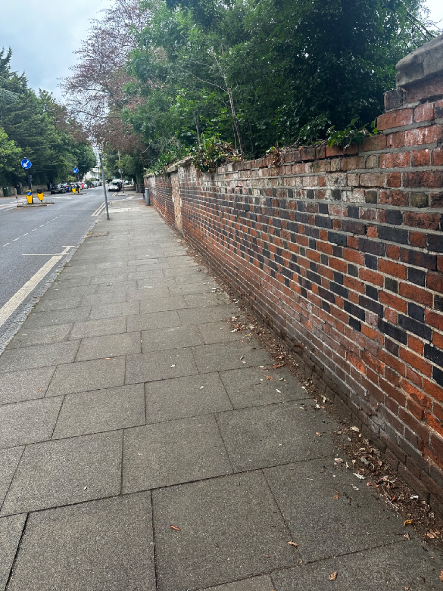 Deteriorating Victorian boundary wall on Westcombe Park Road SE3 Blackheath before rebuilding — crumbling mortar and failing brickwork